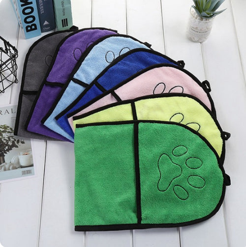 Set of colorful pet towels with paw prints on a white surface