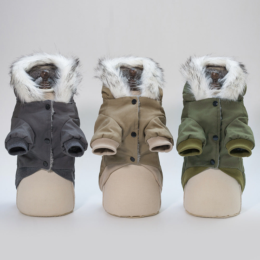 Three dog coats with fur-lined hoods in gray, beige, and green on mannequins against a white background.