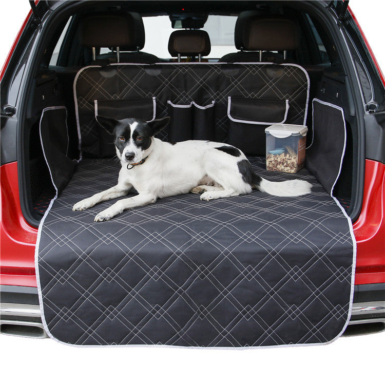 Dog lying on a car bench seat cover with a red car exterior.