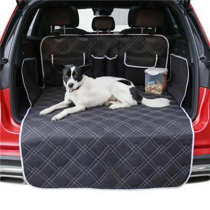 Dog lying on a car bench seat cover with a red car exterior.