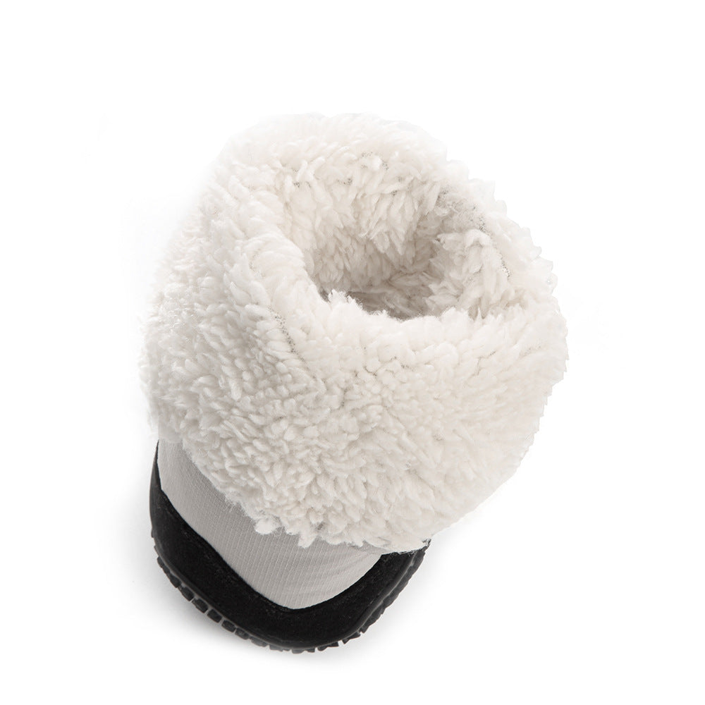 White fuzzy dog boot interior with black sole on a white background