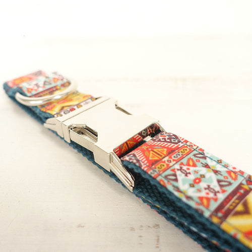 Multicolored patterned dog collar with a silver buckle on a light background